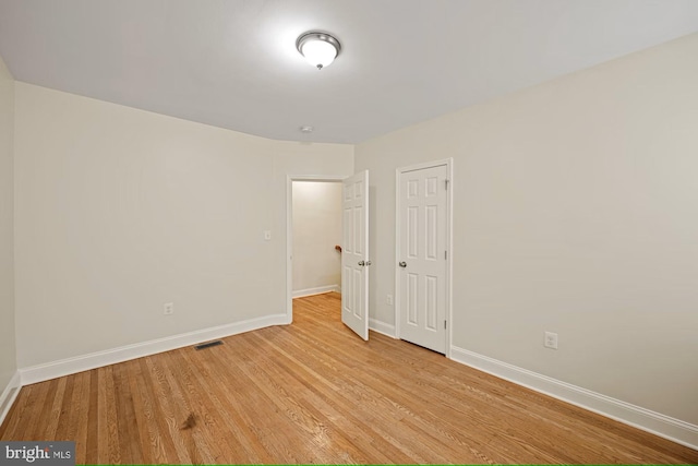 unfurnished room with light wood-type flooring