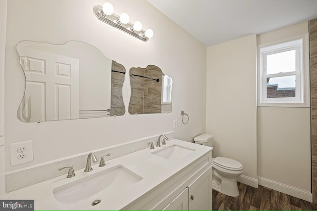 bathroom with vanity, hardwood / wood-style flooring, and toilet