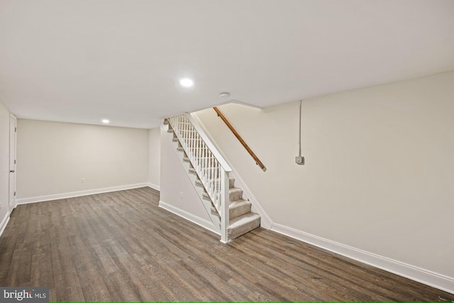 basement featuring dark hardwood / wood-style flooring