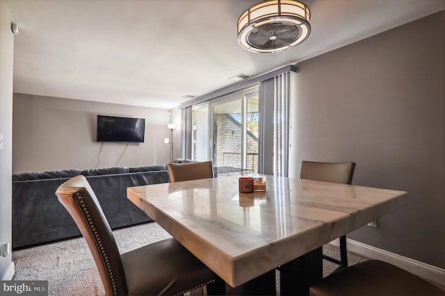 dining space featuring light colored carpet