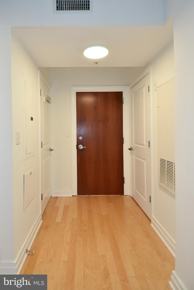 corridor with light hardwood / wood-style flooring