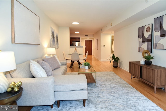 living room with light hardwood / wood-style flooring