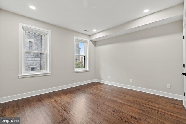 unfurnished room featuring dark wood-type flooring