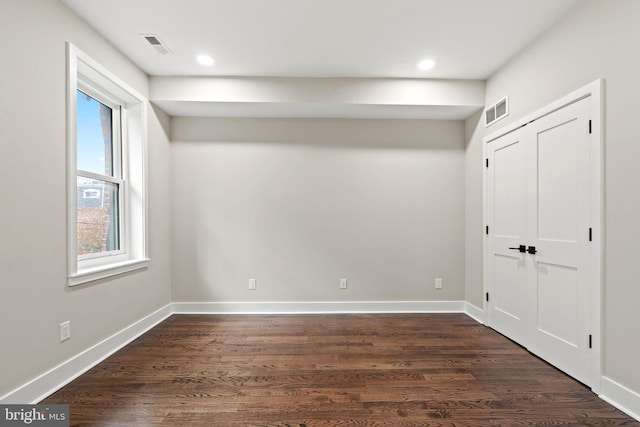 unfurnished room featuring dark hardwood / wood-style flooring