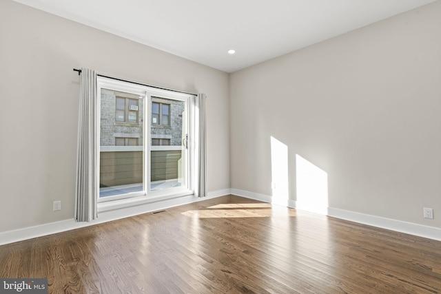 empty room with dark wood-type flooring