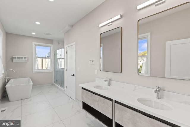 bathroom with vanity and separate shower and tub