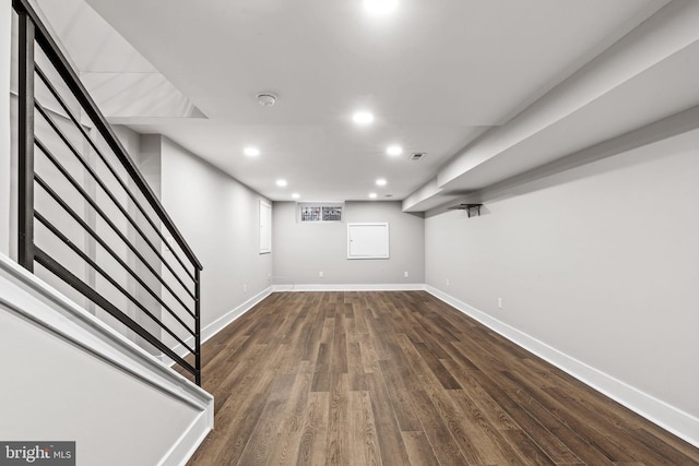 basement with dark hardwood / wood-style floors