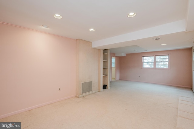 basement featuring light colored carpet