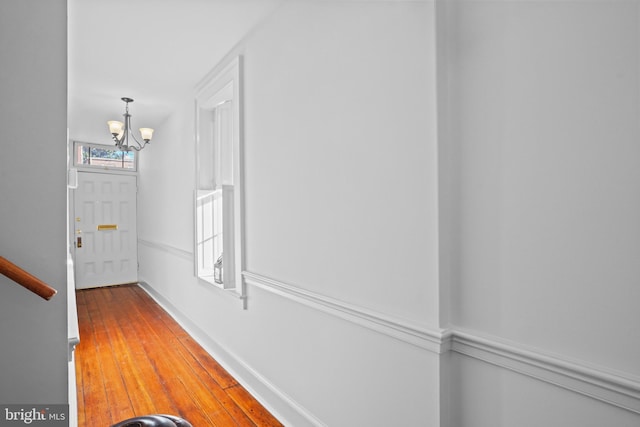 corridor with a notable chandelier