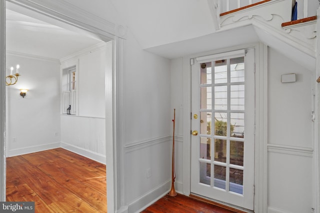 doorway with lofted ceiling and hardwood / wood-style floors