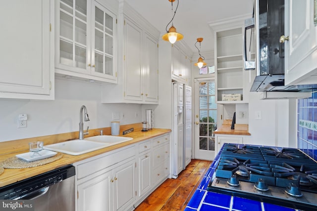 kitchen featuring hanging light fixtures, white cabinets, sink, and dishwasher