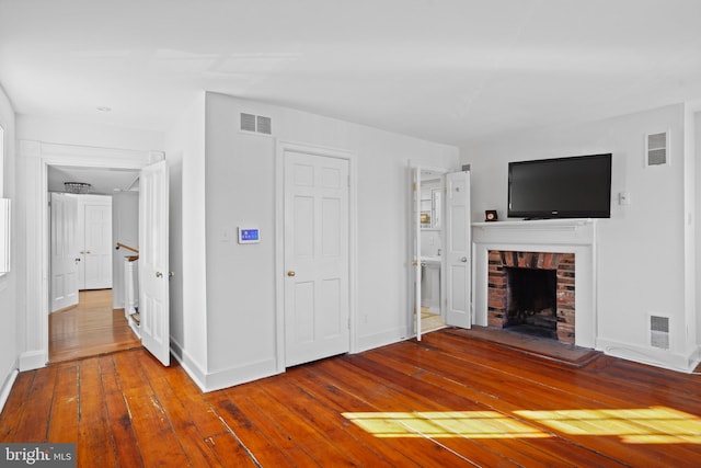 unfurnished living room with a fireplace and hardwood / wood-style floors