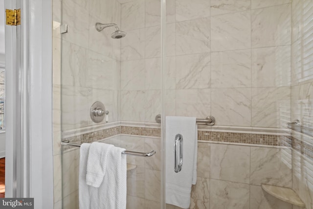 bathroom featuring a shower with door