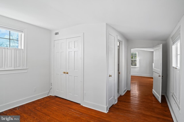 corridor featuring dark hardwood / wood-style floors