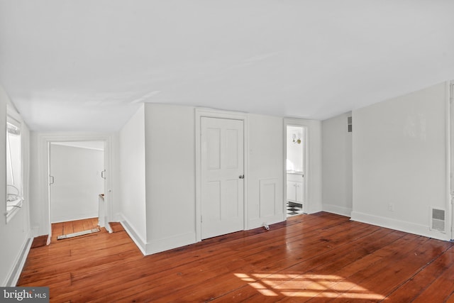 interior space featuring connected bathroom and hardwood / wood-style flooring