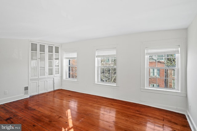 unfurnished room featuring hardwood / wood-style floors