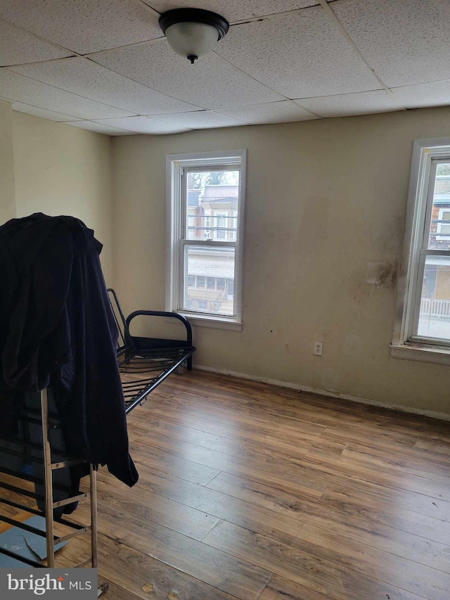 bedroom featuring a paneled ceiling and wood-type flooring