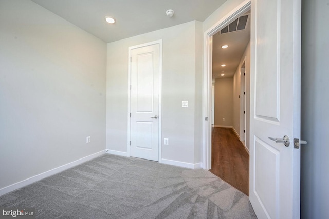 unfurnished bedroom with carpet and a closet