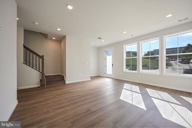 unfurnished living room featuring wood-type flooring