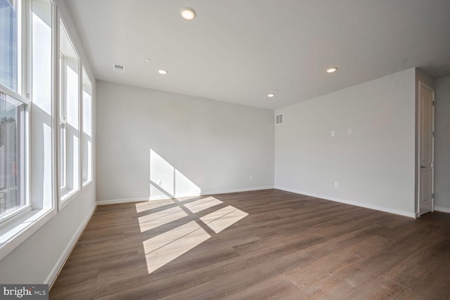 spare room with dark hardwood / wood-style flooring