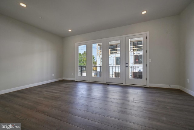 unfurnished room featuring dark wood-type flooring, a healthy amount of sunlight, and french doors