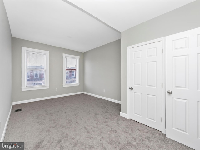 unfurnished bedroom featuring light carpet