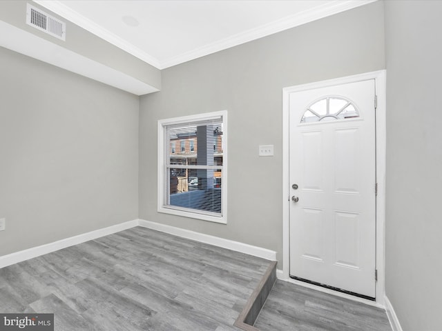 foyer with crown molding and light wood-type flooring