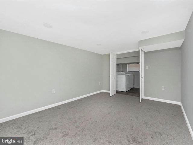 unfurnished bedroom featuring washing machine and dryer and dark colored carpet