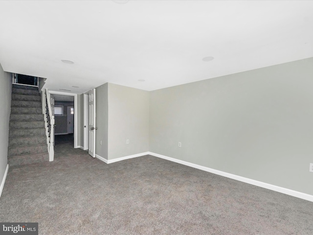 unfurnished room featuring dark colored carpet