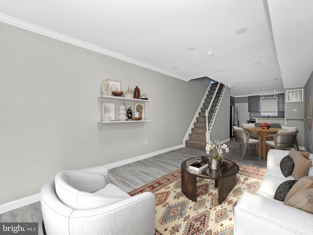 living room with ornamental molding and wood-type flooring