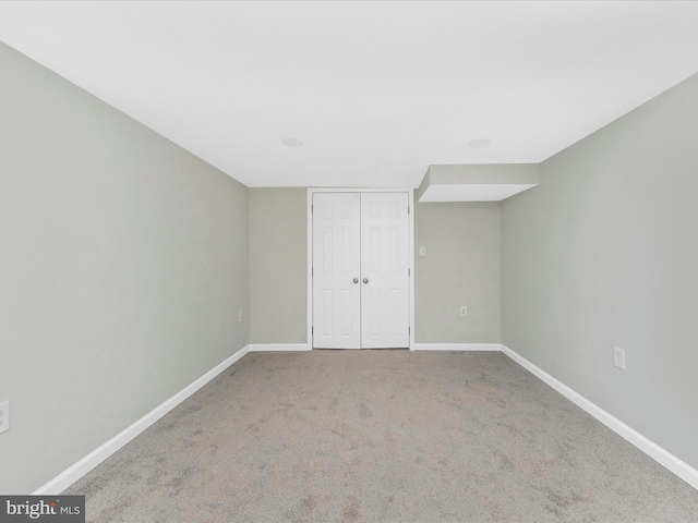 unfurnished bedroom featuring carpet and a closet