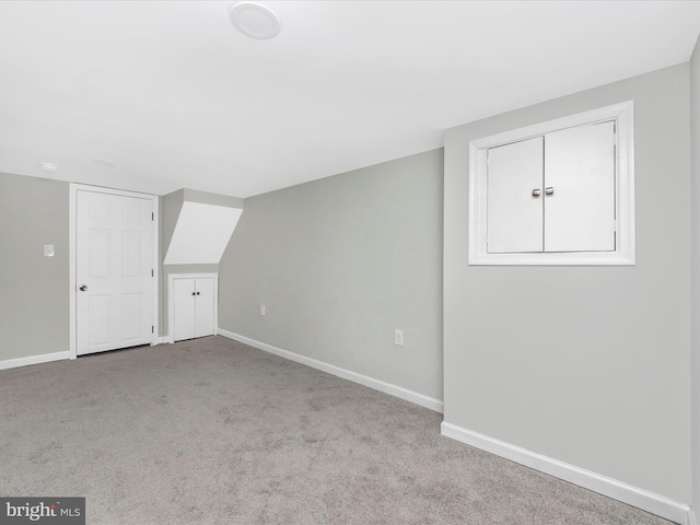 bonus room with light colored carpet