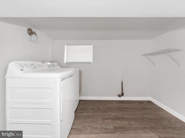 laundry room featuring washer and dryer and dark hardwood / wood-style floors