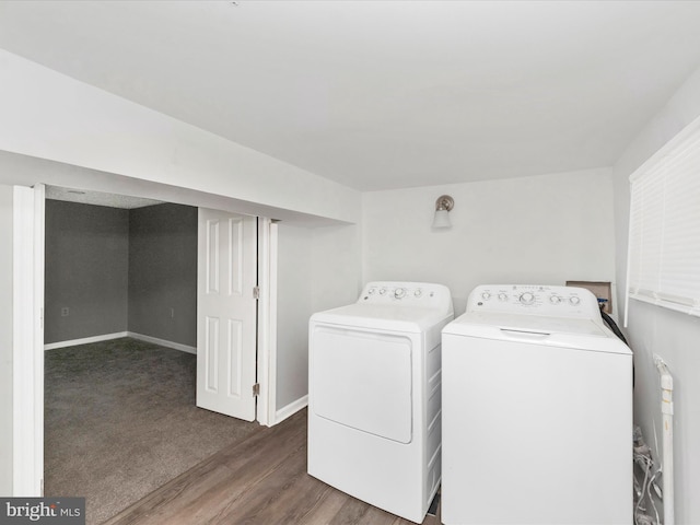 laundry room with dark hardwood / wood-style floors and washing machine and dryer