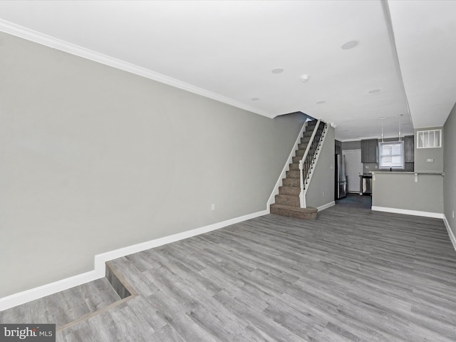 unfurnished living room with dark wood-type flooring and crown molding