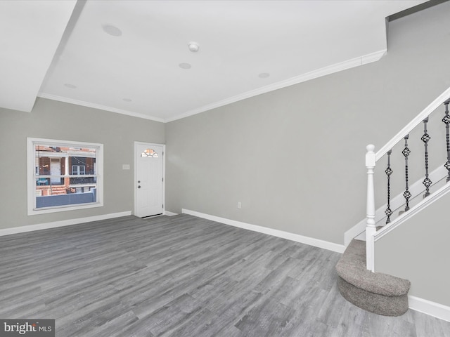 entrance foyer with wood-type flooring and crown molding