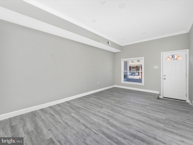 interior space with ornamental molding and light wood-type flooring