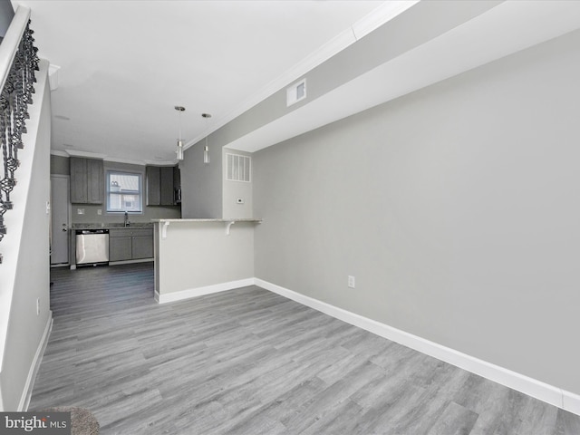 interior space with sink, hardwood / wood-style flooring, and ornamental molding