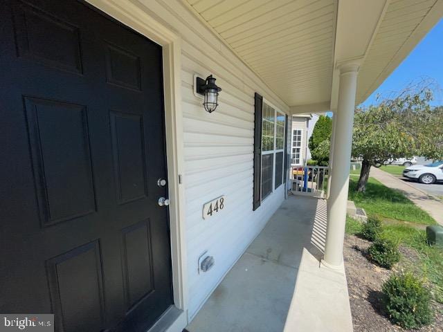 view of exterior entry with a porch