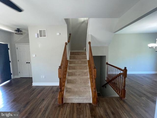 stairway featuring a chandelier and hardwood / wood-style floors