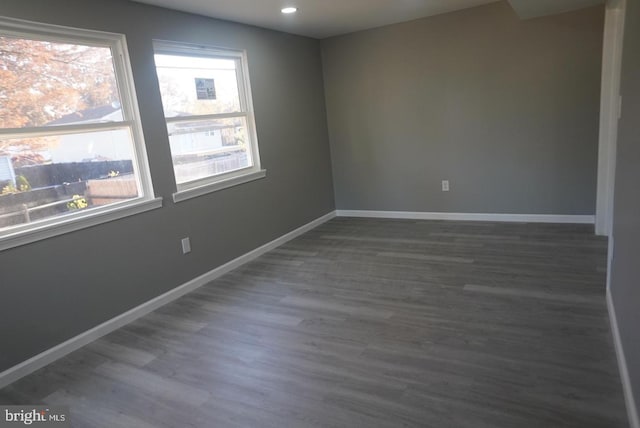 spare room with dark wood-type flooring