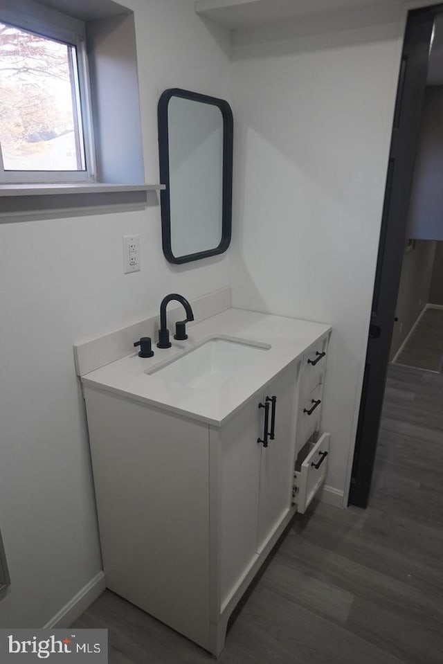 bathroom with hardwood / wood-style flooring and vanity