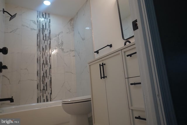 bathroom with tiled shower / bath combo and toilet