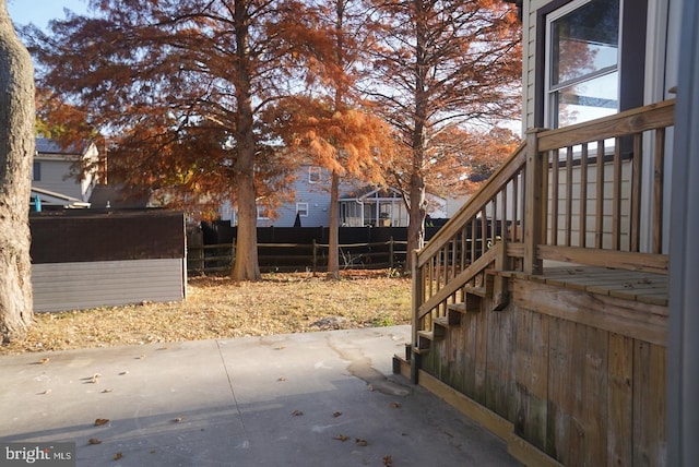 view of yard with a shed and a patio area