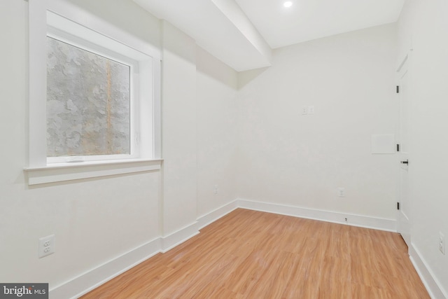 unfurnished room with hardwood / wood-style flooring