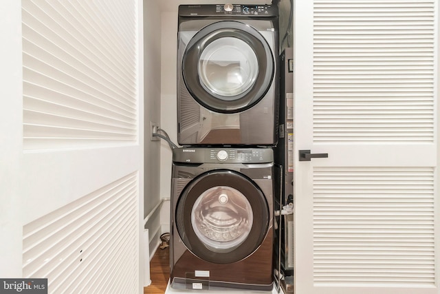 washroom featuring stacked washer / dryer