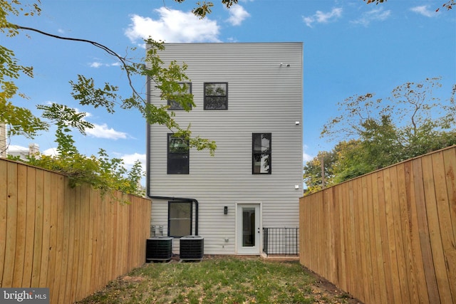 rear view of house featuring central AC unit