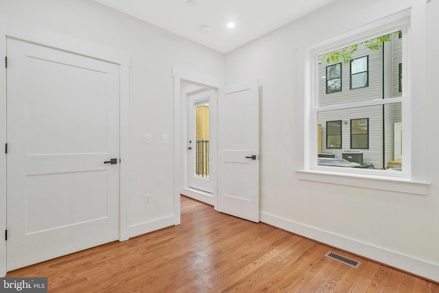 unfurnished bedroom with light wood-type flooring