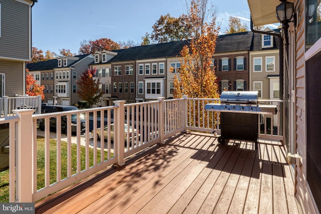 wooden deck featuring a grill