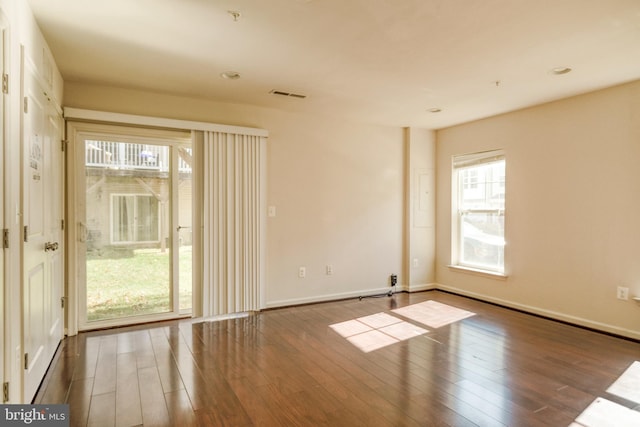 unfurnished room featuring dark wood-type flooring